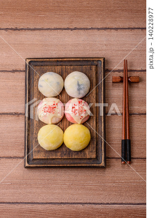 Japanese sweet frozen mochi with rice dough, fruit, and chocolate filling. Japanese mochi Japanese sweet frozen mochi with rice dough, fruit, and chocolate filling. Japanese mochi 140228977