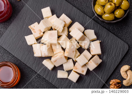 White feta, tofu, or mozzarella cheese cubes with herbs. White mozzarella cheese White feta, tofu, or mozzarella cheese cubes with herbs. White mozzarella cheese 140229003