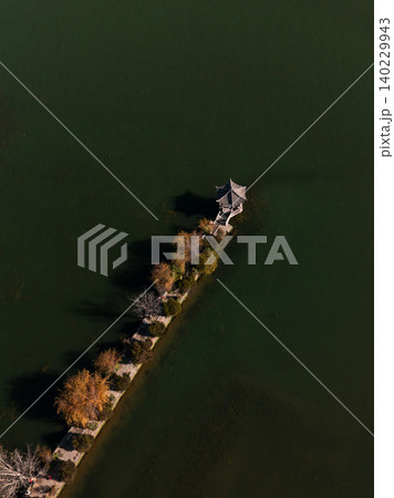 Aerial View of Erhai Lake in Dali, China with Autumn Trees and Pavilion Aerial View of Erhai Lake in Dali, China with Autumn Trees and Pavilion 140229943