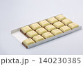 Chocolate bar with white topping closeup on white. 140230385