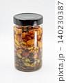 Glass jar with mixed nuts and honey closeup on white. 140230387