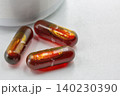 Medical capsules with liquid filling closeup on white. 140230390