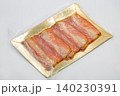 Vacuum packed slices of smoked fish closeup on white. 140230391