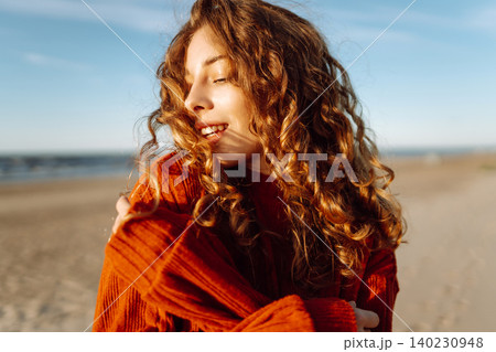 Positive young female in warm clothes smiling and looking at camera. Spring time. Travel, weekend. 140230948