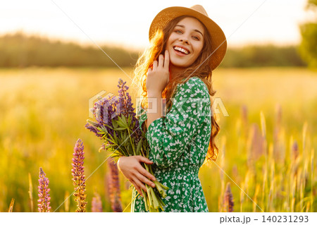 Young woman enjoying nature at sunset while walking. Nature concept. Young woman enjoying nature at sunset while walking. Nature concept. 140231293