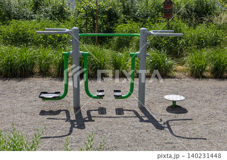 Green fitness machine at outdoor park gym Green fitness machine at outdoor park gym 140231448
