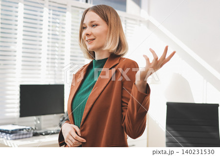 Woman smiling to herself as she works in an office Woman smiling to herself as she works in an office 140231530