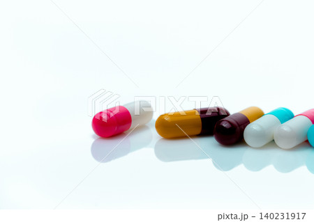 Multi-color antibiotic capsule pills on white background. Antibiotic drug resistance. Prescription drugs. Polypharmacy concept. Pharmacy drugstore product. Pharmaceutical industry. Capsule manufacture 140231917