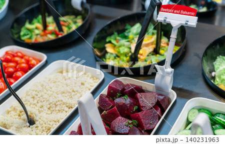 Salad bar buffet at restaurant. Fresh salad bar buffet for lunch or dinner. Healthy food. Beetroot and balsamic in bowl on counter. Catering food. Vegetarian food. Healthy eating. Plant-based diet. 140231963