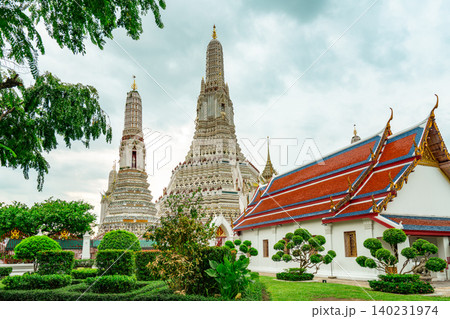 Wat Arun Ratchawararam with beautiful blue sky and white clouds. Wat Arun buddhist temple is the landmark in Bangkok, Thailand. Attraction art and ancient architecture in Bangkok, Thailand. 140231974