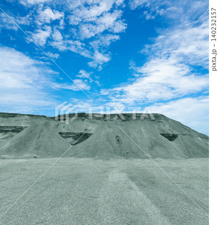 Industrial pile of mined crushed stone at limestone quarry, used for construction materials. Raw material mining for infrastructure projects. Limestone quarry production for construction industry. 140232157