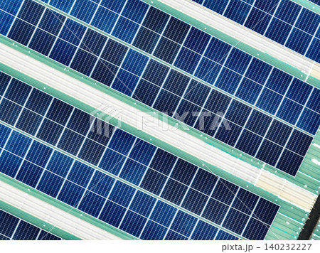 Aerial view of a warehouse rooftop featuring solar panels generating green electricity. The shift to renewable energy, clean power solutions, and environmental sustainability for modern industries. 140232227