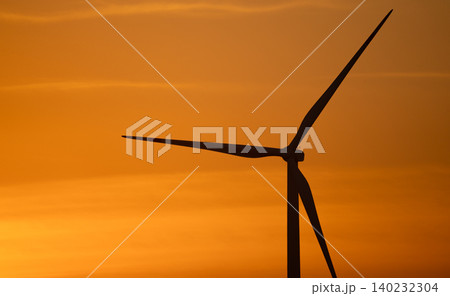 Wind turbine silhouette against sunset sky. Wind power. Sustainable renewable energy generation. Green technology for eco-friendly power production and environmental conservation. Natural landscape. Wind turbine silhouette against sunset sky. Wind power. Sustainable renewable energy generation. Green technology for eco-friendly power production and environmental conservation. Natural landscape. 140232304