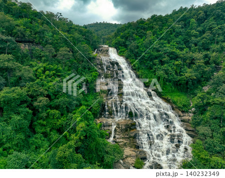 Aerial view of a waterfall in a lush tropical green forest in Doi Inthanon National Park, Chiang Mai, Thailand. This nature landscape showcases water sustainability and scenic travel destinations. 140232349