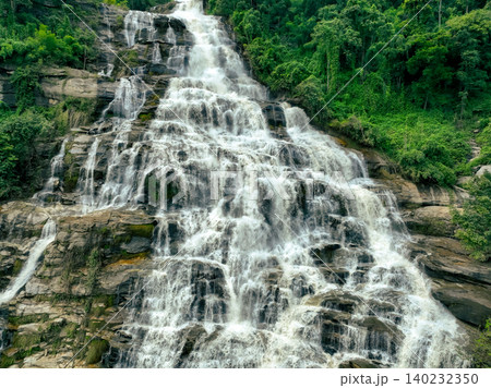 Aerial view of a waterfall in a lush tropical green forest in Doi Inthanon National Park, Chiang Mai, Thailand. This nature landscape showcases water sustainability and scenic travel destinations. 140232350