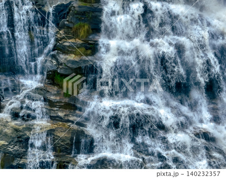 Aerial view of a waterfall in a lush tropical green forest in Doi Inthanon National Park, Chiang Mai, Thailand. This nature landscape showcases water sustainability and scenic travel destinations. Aerial view of a waterfall in a lush tropical green forest in Doi Inthanon National Park, Chiang Mai, Thailand. This nature landscape showcases water sustainability and scenic travel destinations. 140232357