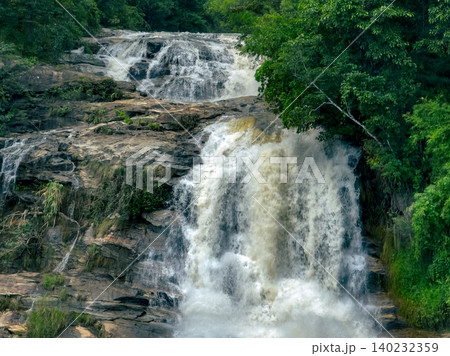 Waterfall in a lush tropical green forest in Doi Inthanon National Park, Chiang Mai, Thailand. This nature landscape showcases water sustainability and scenic travel destinations. Water conservation. Waterfall in a lush tropical green forest in Doi Inthanon National Park, Chiang Mai, Thailand. This nature landscape showcases water sustainability and scenic travel destinations. Water conservation. 140232359