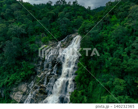 Aerial view of a waterfall in a lush tropical green forest in Doi Inthanon National Park, Chiang Mai, Thailand. This nature landscape showcases water sustainability and scenic travel destinations. 140232365