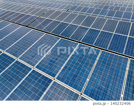 Aerial view of solar farm. Sustainable renewable energy and modern photovoltaic technology for eco-friendly electricity production. Solar power station. Green energy solutions. Solar panel technology. Aerial view of solar farm. Sustainable renewable energy and modern photovoltaic technology for eco-friendly electricity production. Solar power station. Green energy solutions. Solar panel technology. 140232406