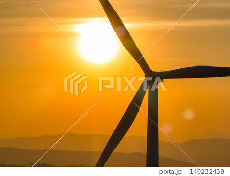 Wind farm field and sunset sky. Wind power. Sustainable, renewable energy. Wind turbines generate electricity. Sustainable development. Green technology for energy sustainability. Eco-friendly energy. Wind farm field and sunset sky. Wind power. Sustainable, renewable energy. Wind turbines generate electricity. Sustainable development. Green technology for energy sustainability. Eco-friendly energy. 140232439
