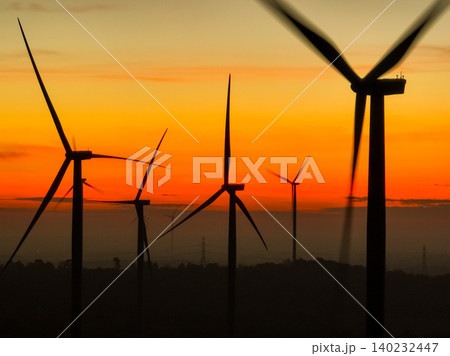 Wind farm field and sunset sky. Wind power. Sustainable, renewable energy. Wind turbines generate electricity. Sustainable development. Green technology for energy sustainability. Eco-friendly energy. Wind farm field and sunset sky. Wind power. Sustainable, renewable energy. Wind turbines generate electricity. Sustainable development. Green technology for energy sustainability. Eco-friendly energy. 140232447