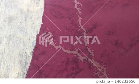 Top view captures scratched red painted surface borders rough weathered cement concrete. Distressed peeling paint textures form a rustic abstract industrial background layout template. Top view captures scratched red painted surface borders rough weathered cement concrete. Distressed peeling paint textures form a rustic abstract industrial background layout template. 140232650