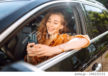 A young woman uses a mobile phone to navigate in the city, pay for parking. Business concept. 140235131