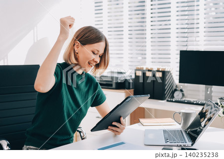 Young beautiful businesswoman works in the office with a laptop. Success 140235238