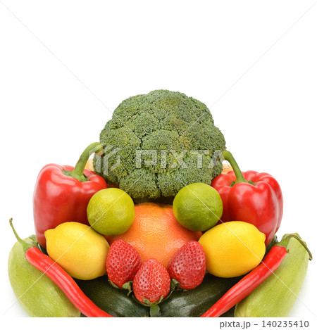 Still life arrangement of fresh organic vegetables and fruits forming a vibrant symmetrical shape isolated on white background. Still life arrangement of fresh organic vegetables and fruits forming a vibrant symmetrical shape isolated on white background. 140235410