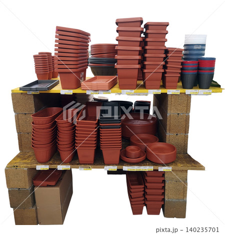 Various flower pots and gardening containers stacked on shelves for sale 140235701