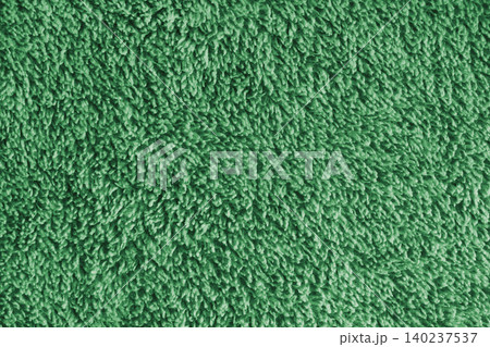 Macro of green microfiber bath towel, soft fluffy fabric, absorbent material texture background Macro of green microfiber bath towel, soft fluffy fabric, absorbent material texture background 140237537