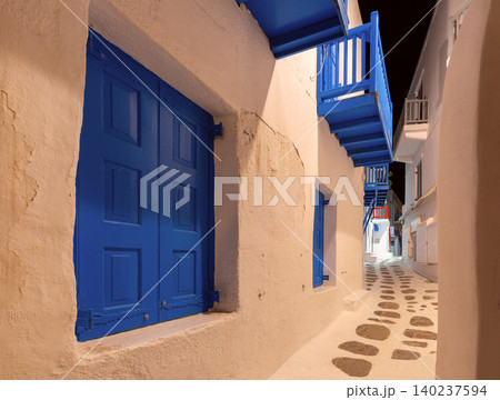 Narrow street with balconies in Mykonos, Greece at night Narrow street with balconies in Mykonos, Greece at night 140237594