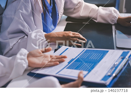 Medical Team Meeting, Doctors Taking Notes During Briefing Session Medical Team Meeting, Doctors Taking Notes During Briefing Session 140237718