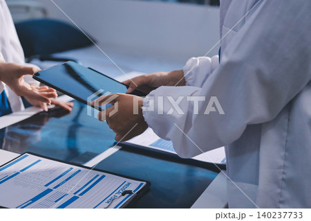 Medical Team Meeting, Doctors Taking Notes During Briefing Session Medical Team Meeting, Doctors Taking Notes During Briefing Session 140237733