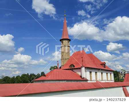Red-roofed tower stands tall against blue sky. Gatchina. Red-roofed tower stands tall against blue sky. Gatchina. 140237829