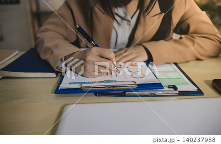 Business accounting concept, Business man using calculator with computer laptop, budget and loan paper in office. Business accounting concept, Business man using calculator with computer laptop, budget and loan paper in office. 140237988