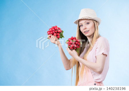 Young woman holding radish Young woman holding radish 140238196