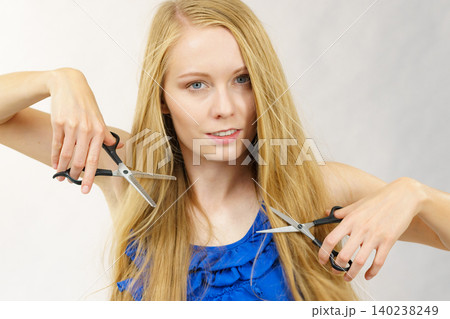 Girl with scissors for haircutting Girl with scissors for haircutting 140238249