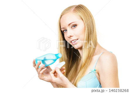 Woman using cleanser cosmetic Woman using cleanser cosmetic 140238268