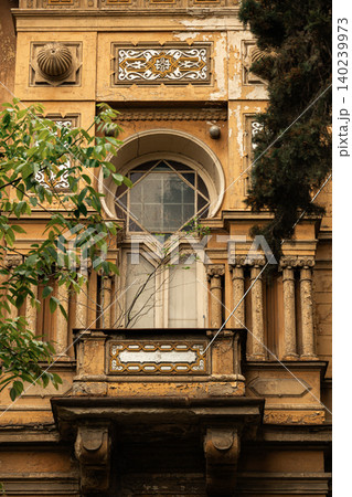 Weathered Historic Building Facade with Ornate Balcony Weathered Historic Building Facade with Ornate Balcony 140239973