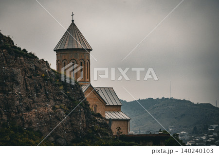 Historic Hilltop Church Emerging from Rocky Cliff Landscape Historic Hilltop Church Emerging from Rocky Cliff Landscape 140240103