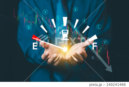 Fuel price and energy crisis concept. Businessman holding fuel gauge showing empty with falling stock market chart and currency symbols. Fuel price and energy crisis concept. Businessman holding fuel gauge showing empty with falling stock market chart and currency symbols. 140241466