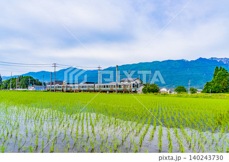 【長野県】北アルプスを背に、田植えの済んだ田園を走る電車 【長野県】北アルプスを背に、田植えの済んだ田園を走る電車 140243730