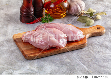 Raw rabbit fillets on wooden cutting board with spices and garlic Raw rabbit fillets on wooden cutting board with spices and garlic 140244650