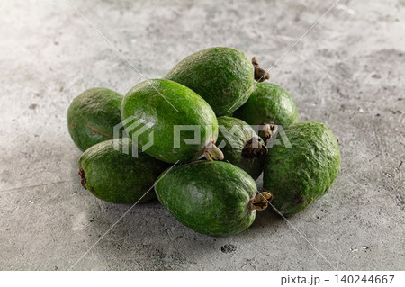 Fresh Green Feijoa Fruits Piled on Textured Concrete Surface 140244667