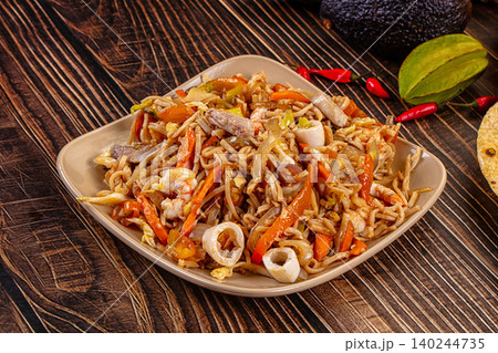 Seafood stir fried noodles with vegetables served on plate Seafood stir fried noodles with vegetables served on plate 140244735