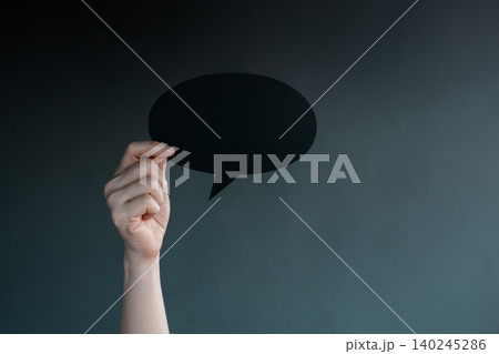 Holding blank speech bubble in dark , Social pressure, emotional expression, mental health Holding blank speech bubble in dark , Social pressure, emotional expression, mental health 140245286