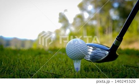 Golf clubs and balls on a green lawn in a beautiful golf course with morning sunshine. Golf clubs and balls on a green lawn in a beautiful golf course with morning sunshine. 140245320