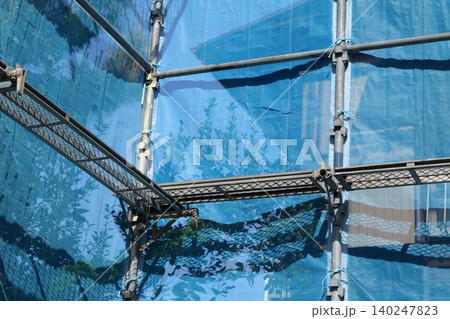 Japanese Construction Scaffolding with Safety Netting Japanese Construction Scaffolding with Safety Netting 140247823