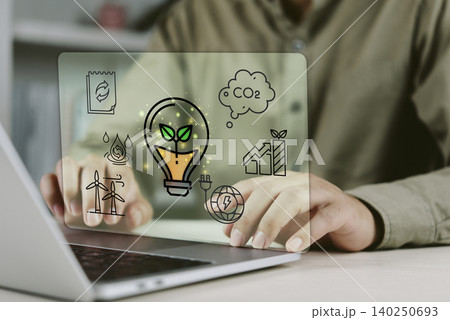 Business person using laptop with ESG environmental, social and governance hologram icons. Concept of sustainable development, green energy, carbon footprint reduction and corporate responsibility. Business person using laptop with ESG environmental, social and governance hologram icons. Concept of sustainable development, green energy, carbon footprint reduction and corporate responsibility. 140250693